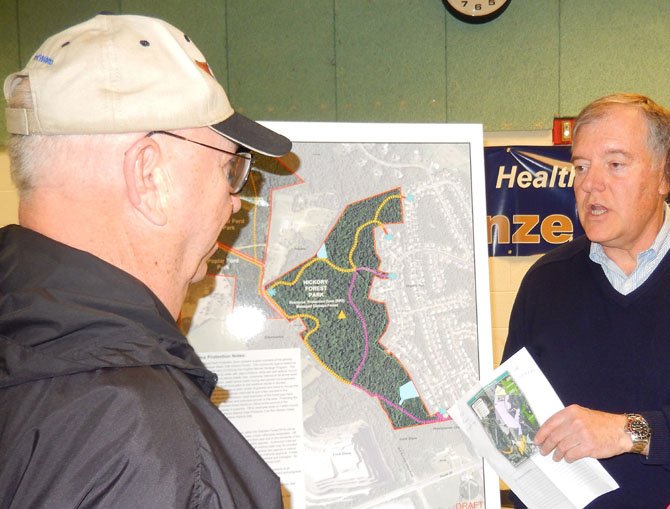 Sully District Planning Commissioner John Litzenberger (on right) discusses the Hickory Forest Park with a resident.
