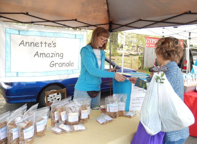 Annette Lane waits on a customer buying her homemade granola.