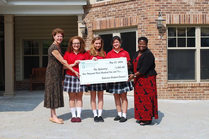 Oakcrest senior council presents the Sylvestery with a $1300 check. From left: Kathleen Martin, CEO of Vinson Hall, Cathryn Grace Sreco, Gianna Ridout and Alex Aguilar and Robin Walker, clinical manager of the Sylvestery