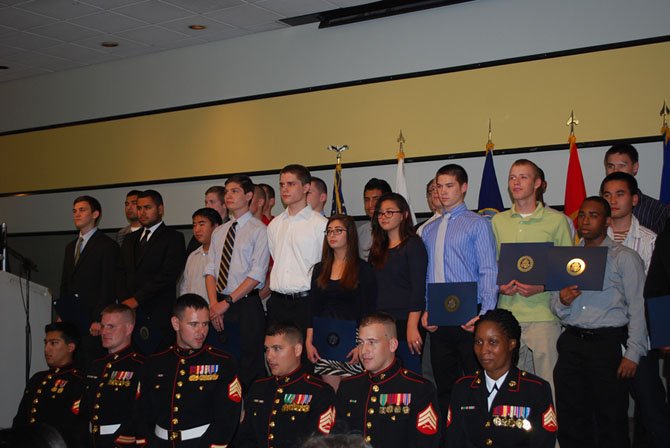 The Marine Corps enlistees of Fairfax, Loudon and Prince William counties stand with their recruitment officers at the fourth annual Our Community Salutes Enlistee Recognition Ceremony Thursday, May 29.