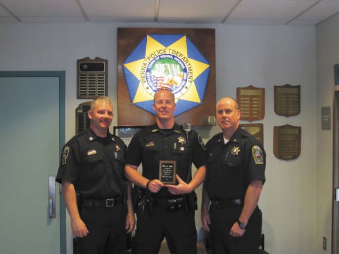 Pictured, from left, are Deputy Chief Dan Janickey, Officer Conor Tracy and Colonel Jim Morris.