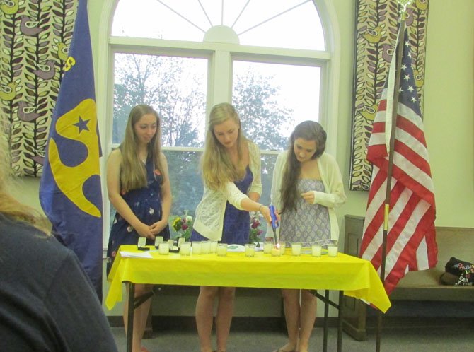 From left, Rachel Zmuda, Caitlin Dalrymple, and Maddie Navin all of Troop 1057, of Great Falls, are honored on May 27, 2014 for completing their Girl Scout Gold Awards. Pictured here, they are reciting the Girl Scout Promise and Law during a candle lighting ceremony.