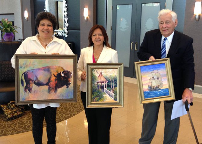 Women’s Club of Potomac Art Show artists presenting their work at a club include artist Julie Smith (left); Pat Choquette (center), show curator/artist/ interior designer with painting, “Secret Refuge,” and Allen Ett (right), historical ship artist with donated painting for the benefit, “The Susan Constant” which carried colonists to Virginia in the early 1600s.