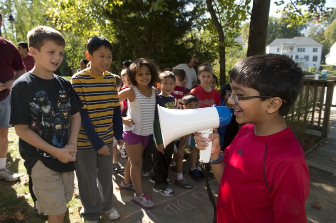 Rohil Bhinge rallies his friends through a megaphone prior to his first Fun Run event.