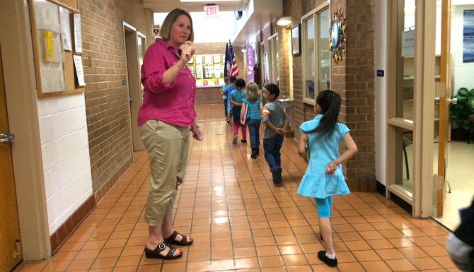 Hybla Valley Elementary School Principal Lauren Sheehy greets students in the hallway.