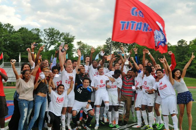 The T.C. Williams boys' soccer team celebrates winning the 6A North region championship on Thursday.