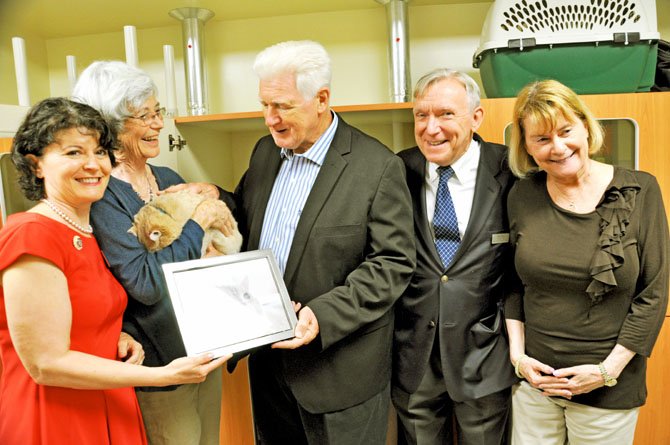 A framed photo of Arrow was presented to Arrow's adopter, Anne Hancock (holding Arrow) along with supporters state Sen. Barbara Favola, U.S. Rep. Jim Moran (D-8), President/CEO of AWLA Neil Trent and Patricia Ragan, AWLA board president.