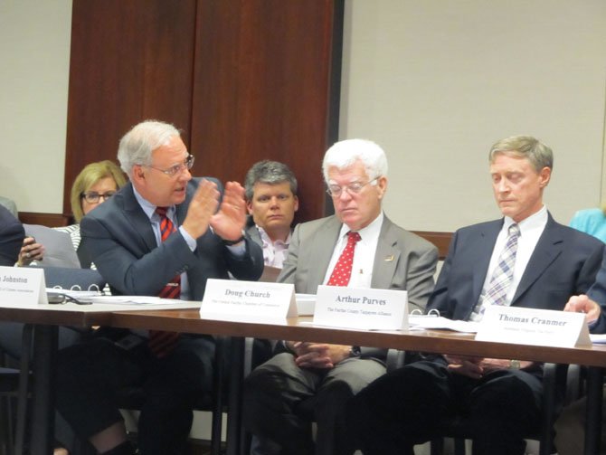 Joseph Johnston, representing the Sully District Council of Citizens Associations, disputes several points with Arthur Purves, who heads the Fairfax County Taxpayer’s Alliance, during the May 29 meeting. 
