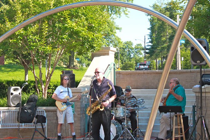 Scott Ramminger & the Crawstickers jam near the public art at the Palladium Civic Place Green Saturday.