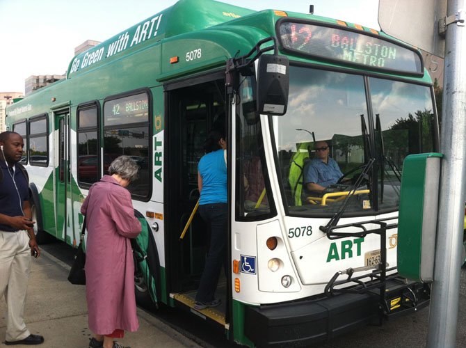 Passengers board an ART bus in the Pentagon City area.