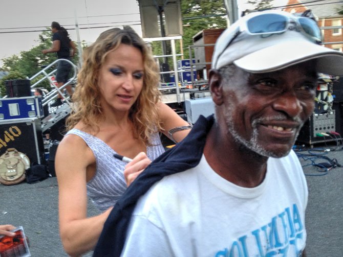Arlington resident Jesse Freeman gets his shirt signed after the annual Columbia Pike Blues Festival on Saturday, June 14 by singer and musician Ana Popovic.
