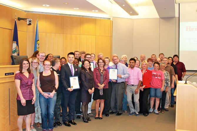 Members of the local LGBT community and supporters with a proclamation noting the group’s contributions to American society in the face of adversity.