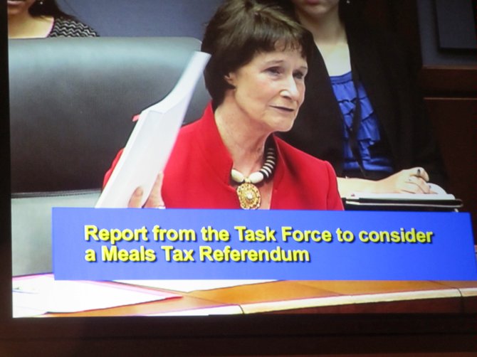 Sharon Bulova, Chairman of the Fairfax County Board of Supervisors, holds up the 170-page final report of the Meals Referendum Task Force. The board deferred any action in order to review the final report in more depth, Bulova said.