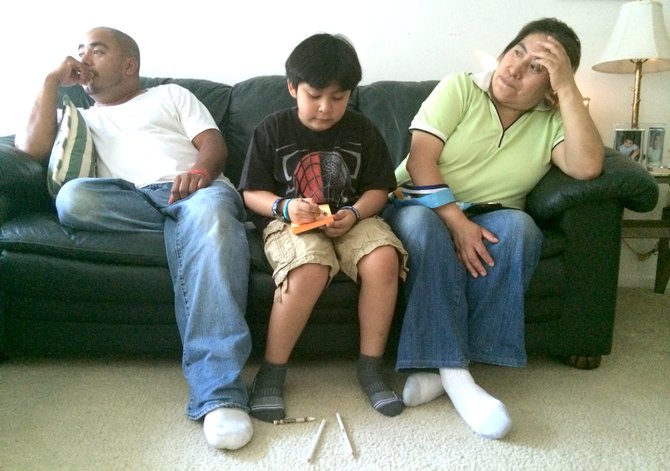 Adrian Pineda, center, is a first-grade student at William Ramsay Elementary School who is worried his parents may not be able to afford living in Alexandria when the apartment where his parents live is demolished.