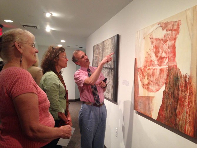 From left, McLean residents Dorothy McFayden, Joanne Muir, and Tovey Bachman observe Jo Fleming’s “Tree House” made of acrylic.
