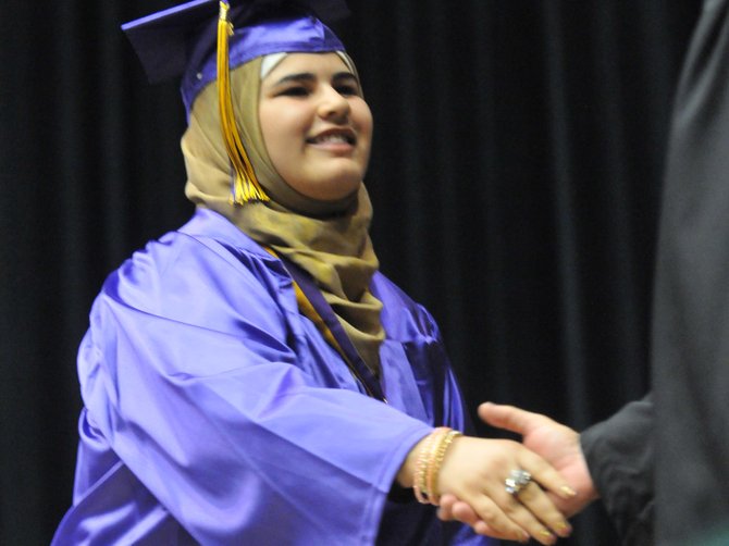 After receiving her diploma, Saja Osama Abduljabbar is congratulated by school principal David F. Thomas.