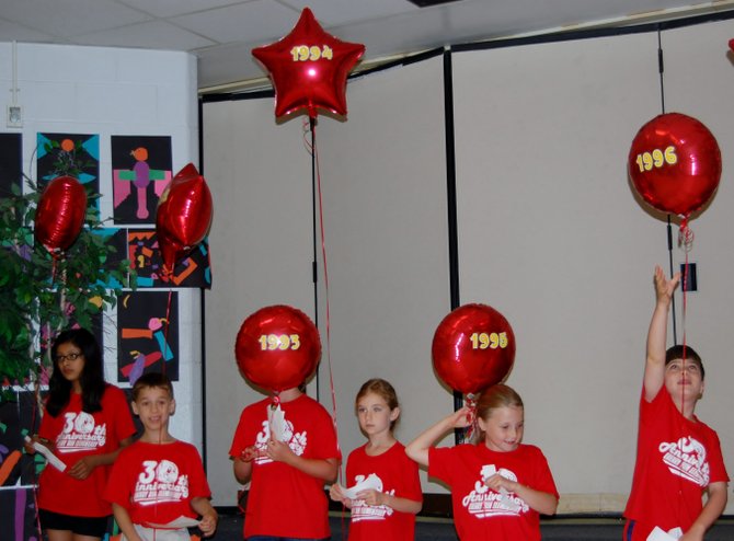 Thirty students were given balloons with a year on it and read a fact corresponding to that year at Cherry Run Elementary School’s 30th anniversary celebration. 