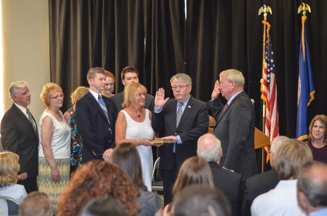 Herndon town council member David Kirby takes his oath of office during a Sunday event at Herndon Municipal Center.