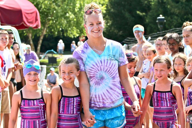 Logan Haddock (center) takes her ceremonial final walk across the Sully Station pool deck, Saturday June 27, in her final meet as an SST. Haddock will attend the University of Tennessee in the fall where she will compete on the swim and dive team. Also pictured are Keira O'Neail, Kennedy O'Neail, Natalya Hamluk and Parker Brooks.
