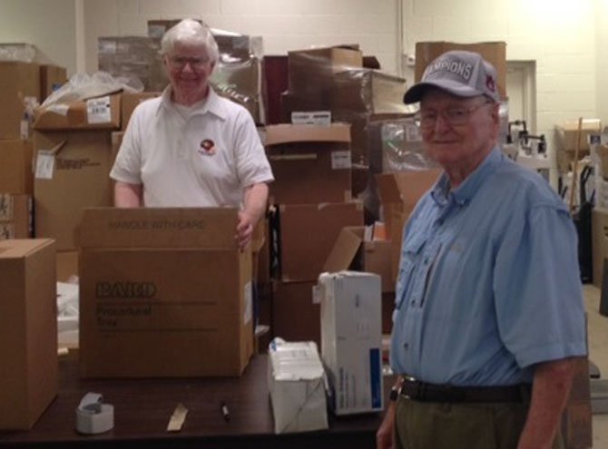 Regular volunteers Jack Murphy and Gene Barksdale help process medical supplies at the Brother’s Brother Foundation warehouse.
