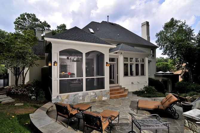 A screen porch addition by Sun Design Remodeling was recently named the nation's best-in-category by the National Association of the Remodeling Industry. The exterior integrates a Mediterranean style home with mature landscaping and a well-developed outdoor activities area.
