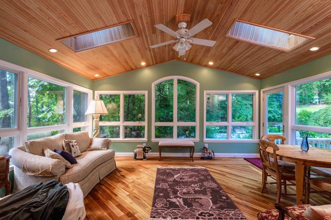 The sun porch solution emphasizes views. Windows are insulated and wind-resistant. To meet code requirements for the larger window panels the owners were seeking, remodeler David Foster developed a steel bracing frame which is concealed behind walls.
