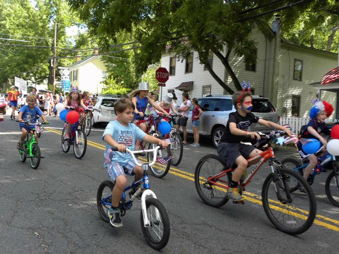 Children on bicycles participate in the Clifton Independence Day Parade.
