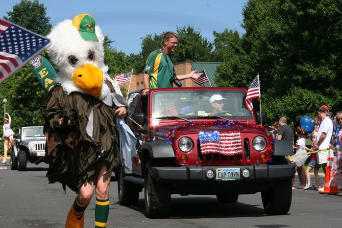 The mascot for the Great Falls Eagles rugby team danced alongside the team car.