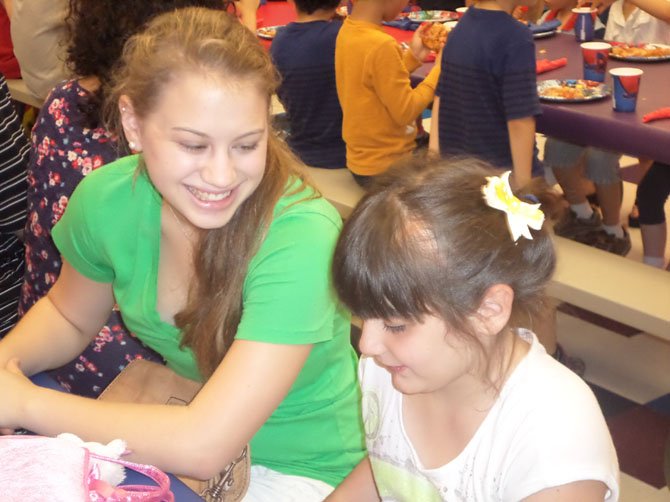 Friendship Circle teen volunteer Allie Wiener plays with her buddy Sophie Gottfried. Friendship Circle pairs special needs children with teenage volunteers who mentor the youngsters.
