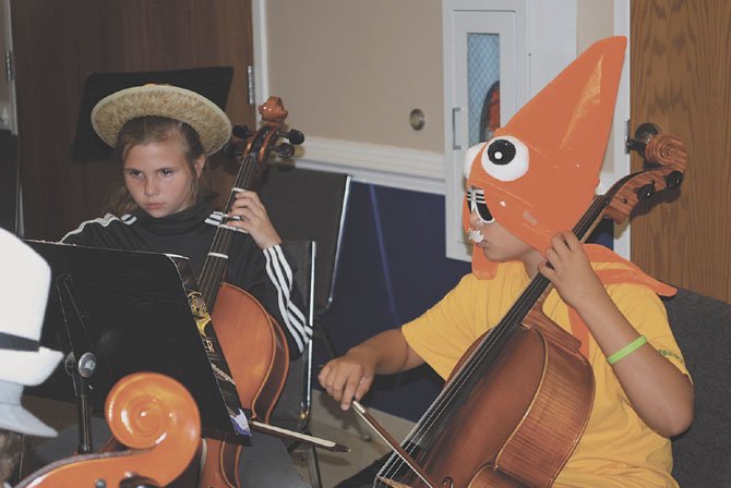 Caroline Cassidy, left, and Luca Seng play their cellos on “Wacky Wednesday” of Summer Strings Camp.