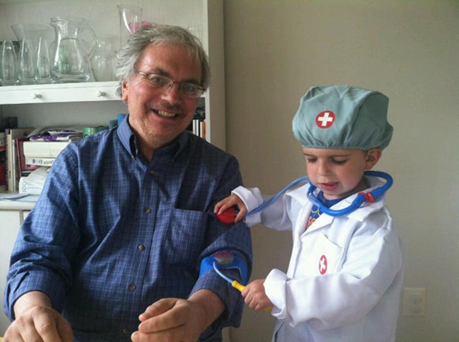 Jim Laurie gets the all-clear during a check-up from 3-year-old grandson Alex five days after undergoing a quadruple bypass at Inova Alexandria Hospital.
