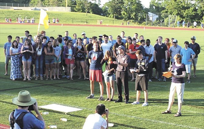 Former Commissioner of the Youth Ultimate Frisbee League of Arlington Deborah Duffy, far right in the front, presents the “Connect with Kids Champions” award from the Arlington Partnership for Children, Youth and Families to Ultimate Frisbee coaches Dave Soles, front left, and Will Smolinski, front center. Standing with Soles and Smolinski are Jay Boyle, second from right in the front, and Jojo Emerson, second from the left in the front, former players for the Yorktown-HB (YHB) Ultimate team. Standing behind them are current and former players from Yorktown and H-B Woodlawn. 
