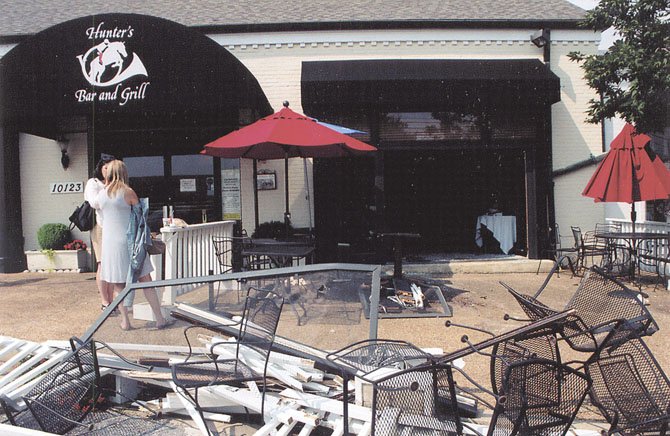 Guests were seated in what was once a fenced-­in patio at Hunter’s Bar and Grill prior to a driver failing to stop her car, jumping the curb, and entering the Polo Room. Two guests were injured. One of the tables not crushed can be seen inside the Polo Room.
