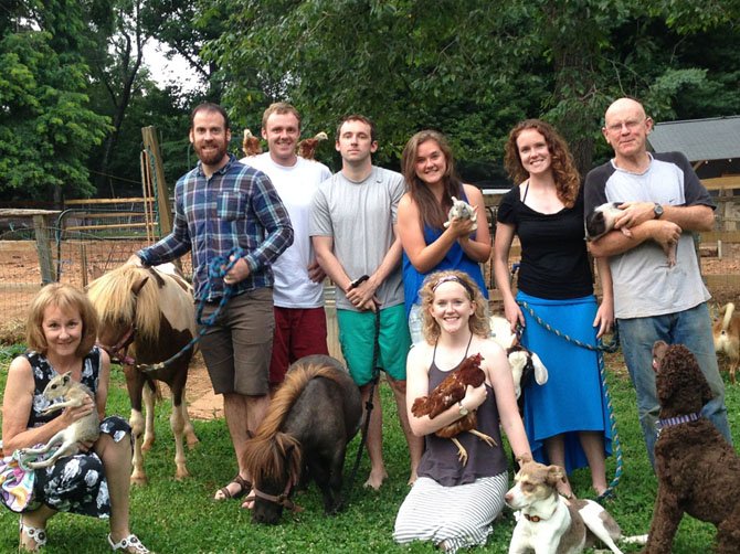 From left: Jill Phillips with Patagonian cavy, Joe Moore with Tinkerbell, Tyler Phillips with two chickens, Grant Phillips with dwarf horse, Raquel Phillips with baby bunny, Chelsea Phillips with Carmela the goat, John Phillips with Buffy the teacup piggy and Marlena with chicken; River the labradoodle, Sneakers the Aussie whippet mix.
