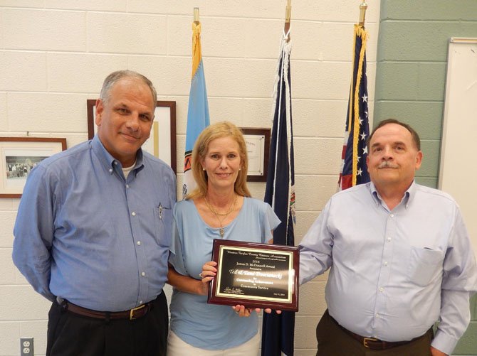 From left: Ted and Tami Troscianecki receive the James D. McDonnell Award for outstanding community service from Jim Katcham.
