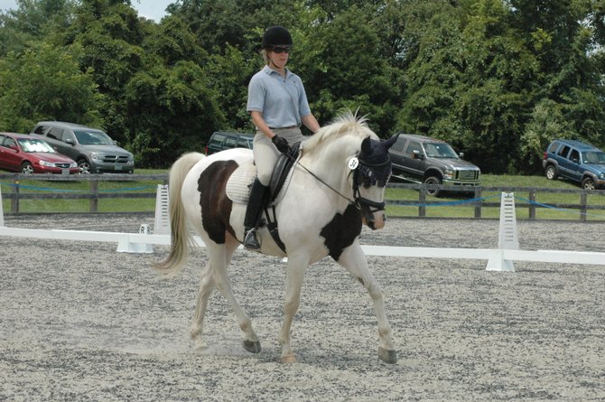 Hope McKalip, another veterinarian on a paint horse, competed on Domino in dressage. She owns the Little Foxes Equine Veterinary service in Vienna. 