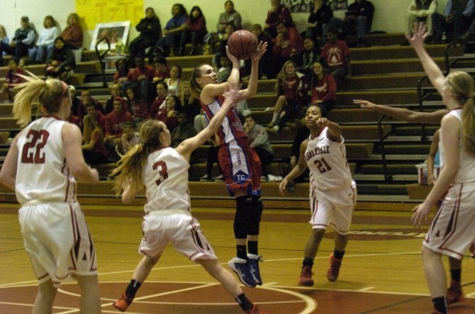 Former T.C. Williams guard Angie Schedler attempts a shot against Annandale during her senior season.