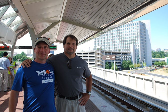 Darren Ewing of McLean and Andy Marshall of Great Falls wait on the platform for the “inaugural ride” on the Silver Line, Saturday, July 26.