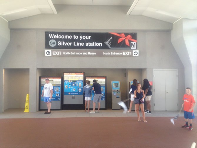 Patrons of the Silver Line get their passes to use the Silver Line station at Spring Hill metro station on July 26. Spring Hill station is near Tysons’ largest residential community.