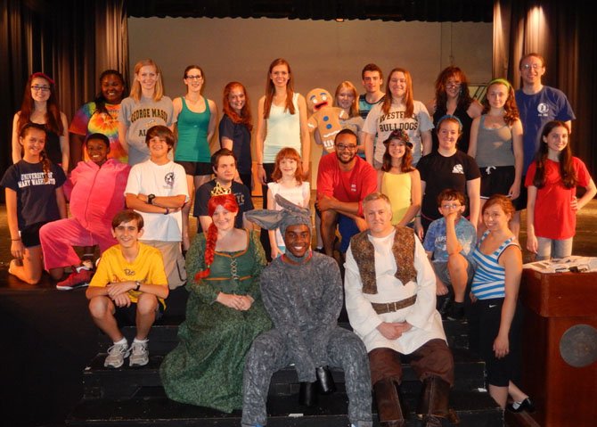 In costume are (from left) Jennifer LePaige (Princess Fiona), Devyn Tinker (donkey) and Glynn Cosker (Shrek) with some of the Summer Stars actors before rehearsing the “Freak Flag” dance number.