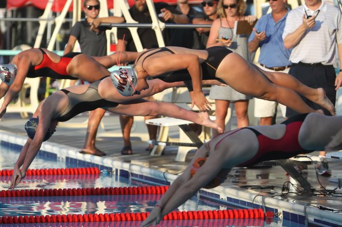 WGCC 18U swimmer Caitlyn O'Berry dives into the pool.
