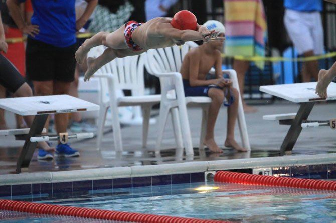 Jack Carman dives in for one of his two 1st-place finishes.