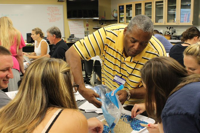 Hutchison Elementary teacher William McCoy helping with a beach erosion experiment. 