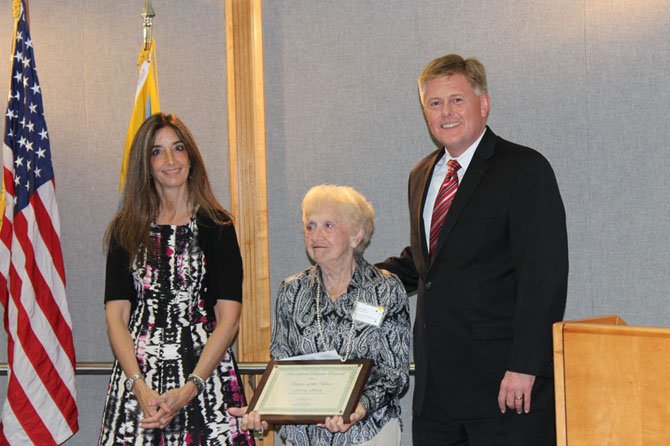 Norma Heck (center) was recognized by the Board of Supervisors on July 29 for her service to the community. She is pictured here receiving an award for being the 2014 Braddock District Citizen of the Year.
