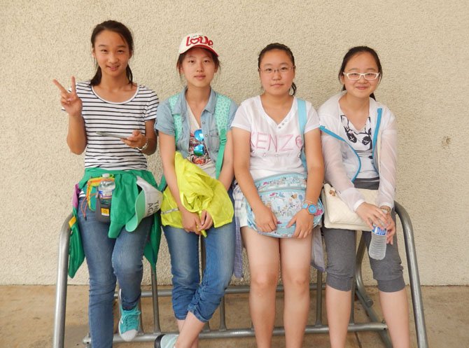 Relaxing together outside Fairfax High’s field house are (from left) Xuan Li, Yike Wang, Yu Ting Yang and Jiang Rong Lou.
