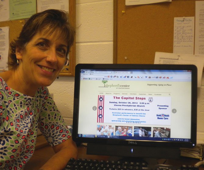Michelle Scott, Executive Director of the Shepherd’s Center of Oakton Vienna (SCOV) is pictured displaying newly launched website for SCOV.