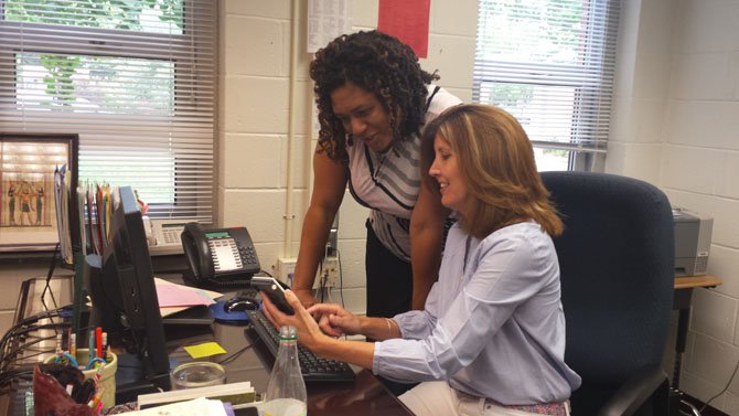 From left--Assistant Principal Janice Dalton and Principal Maureen Boland go over plans for the upcoming school year in Boland’s office at Rolling Valley Elementary School. 
