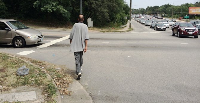 Hamid Farooq tries to cross the intersection of Buckman Road and Route 1, which lacks a crosswalk and pedestrian signals.