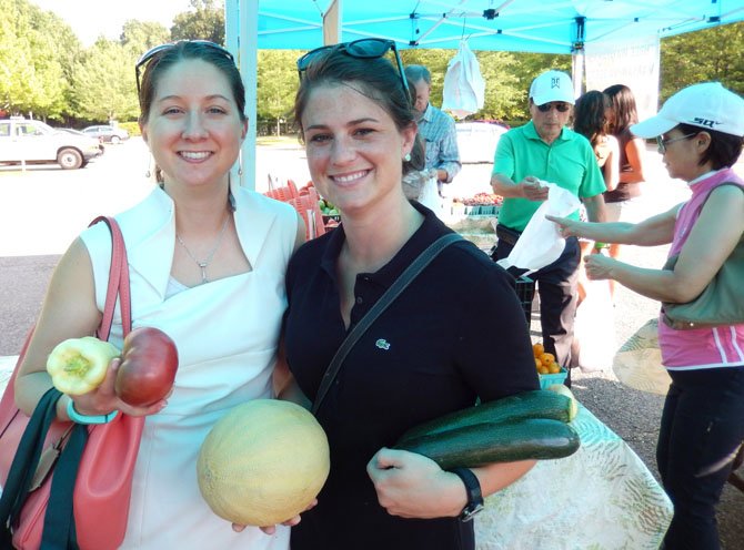 (From left) are Sarah Keally and Whitney Kazragis with their produce purchases.
