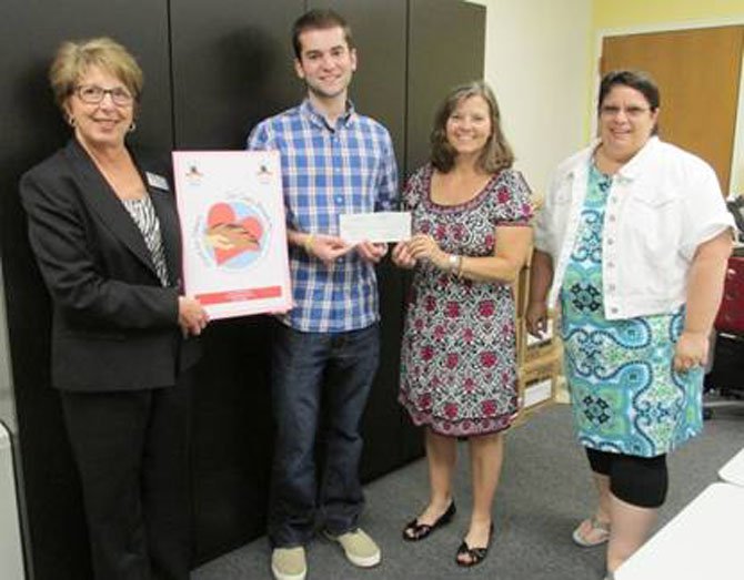 Fairfax City resident and JMU student Brian Wilk receives a $200 prize for creating the winning image for Our Daily Bread and Food for Others' 2014 Complete the Circle FoodRaiser. Presenting him with the check are (from left): Kista Fleming, Vice President and Area Manager of United Bank, an event supporter; Our Daily Bread Executive Director Lisa Whetzel and Food for Others Volunteer and Operations Manager Nikki Clifford.
